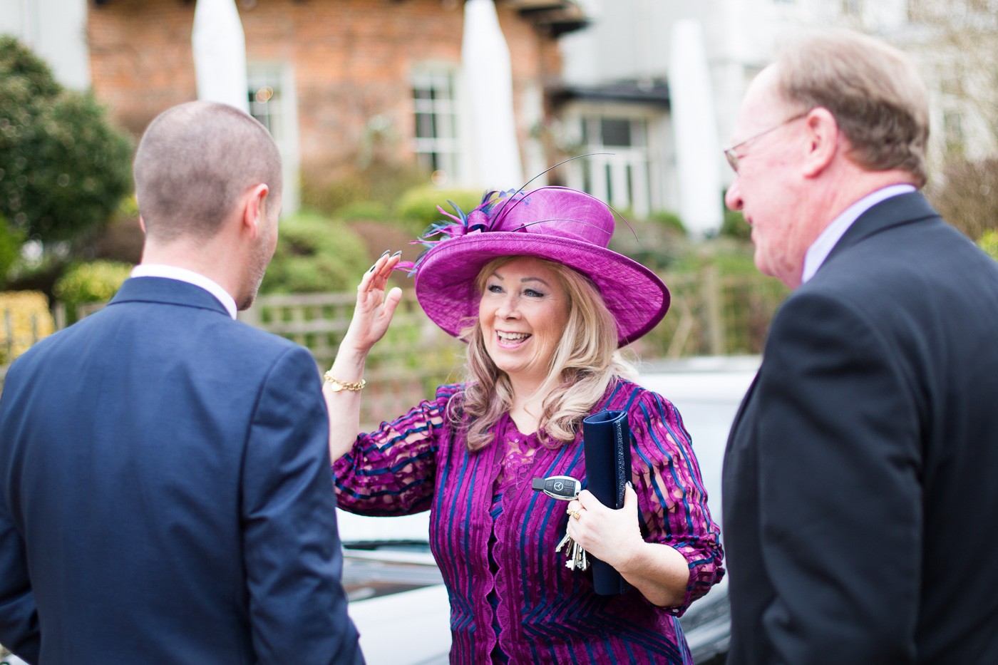 Elegant Lady in purple touching her hat