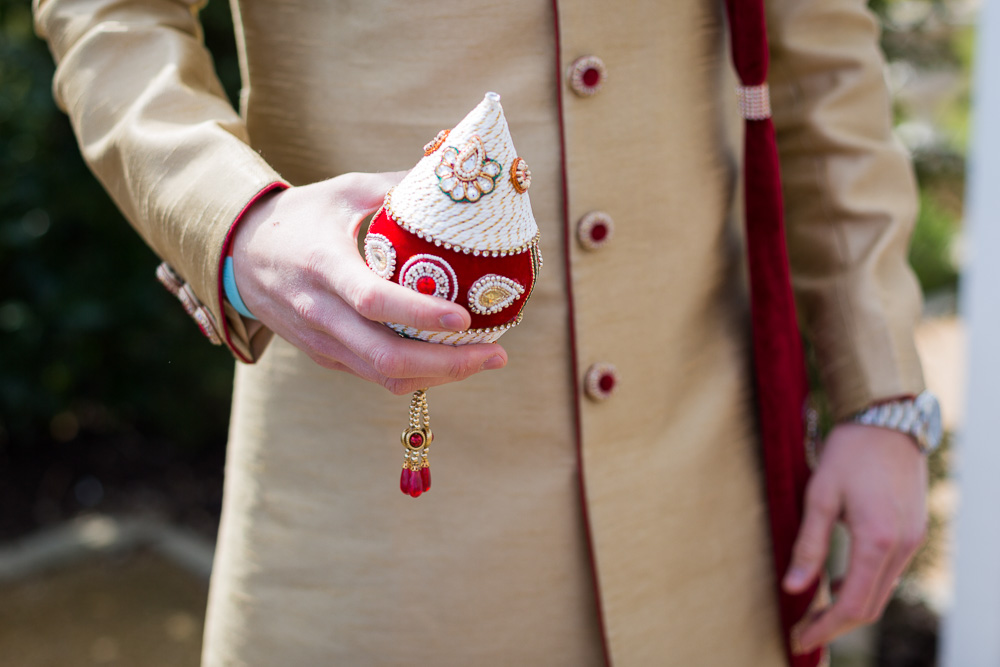 groom holding coconut before the jaan procession