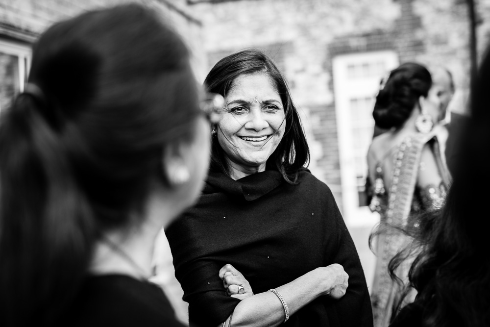 black and white picture of a female guest smiling