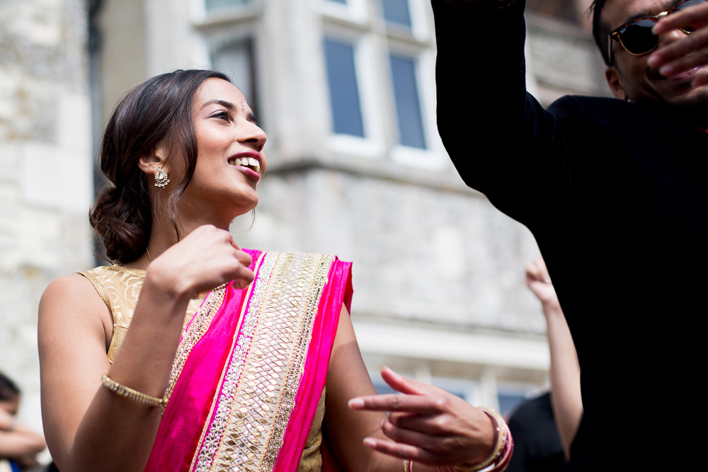 smiling singing female guest in pink sari