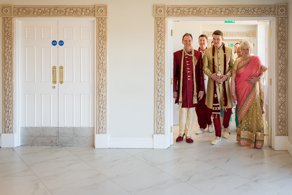 groom and his family entering the wedding ceremony