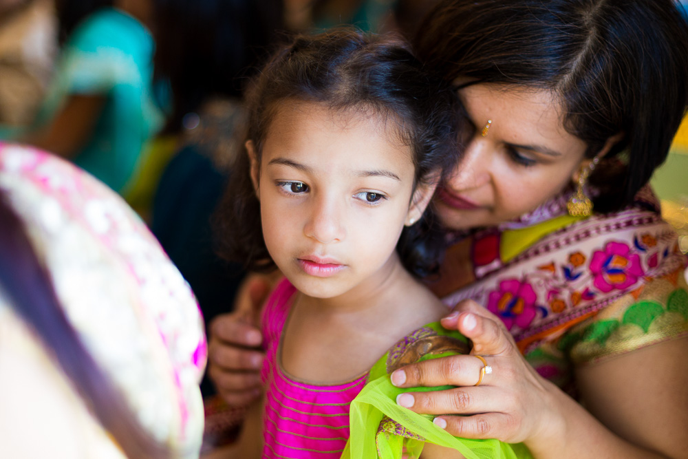 gentle moment between a little girl and her mother in saris