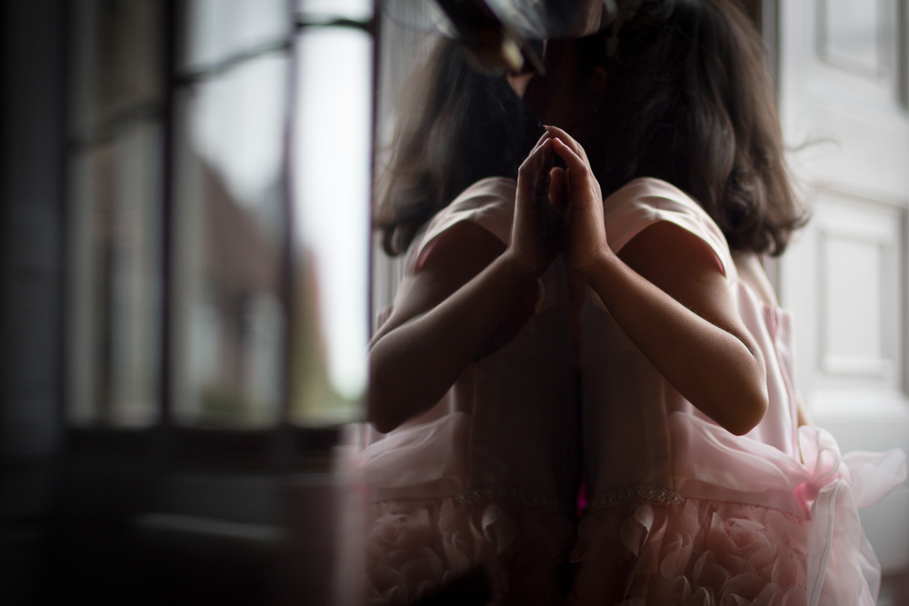 littel girl in a pink tutu reflection on piano
