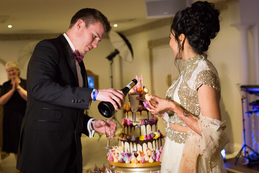 groom pouring champagne for his bride