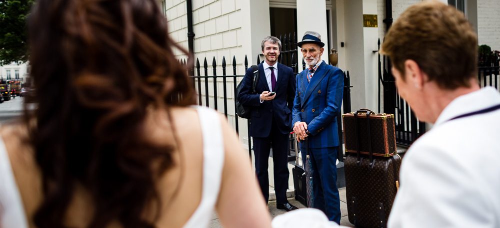 Louis Vuitton dress men looking at bride in Mayfair