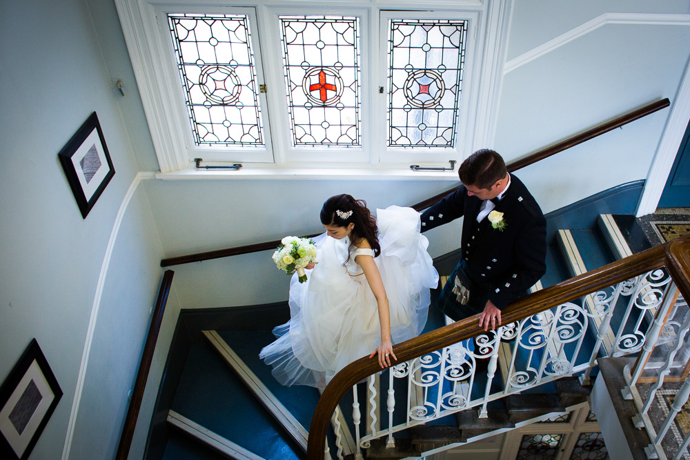 bride and groom walking down the stairs