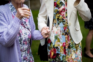 old women holding hands at wedding in Oxford