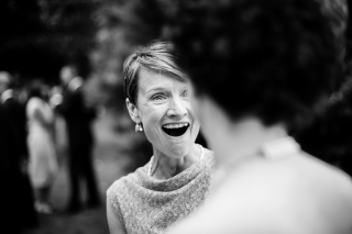 black and white shot of smiling wedding guest