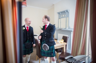 best man and groom chatting