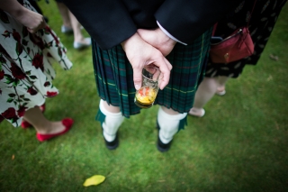 glass of pims and a kilt