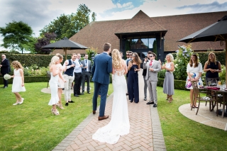 Bride and groom greeting their guests at The old Kent Barn