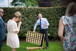 tipsy wedding guest playing board game in the garden
