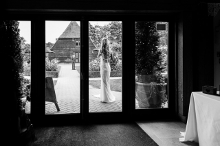Bride waiting for her groom before entering the reception
