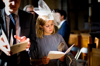 thoughtful wedding guest at the church reading