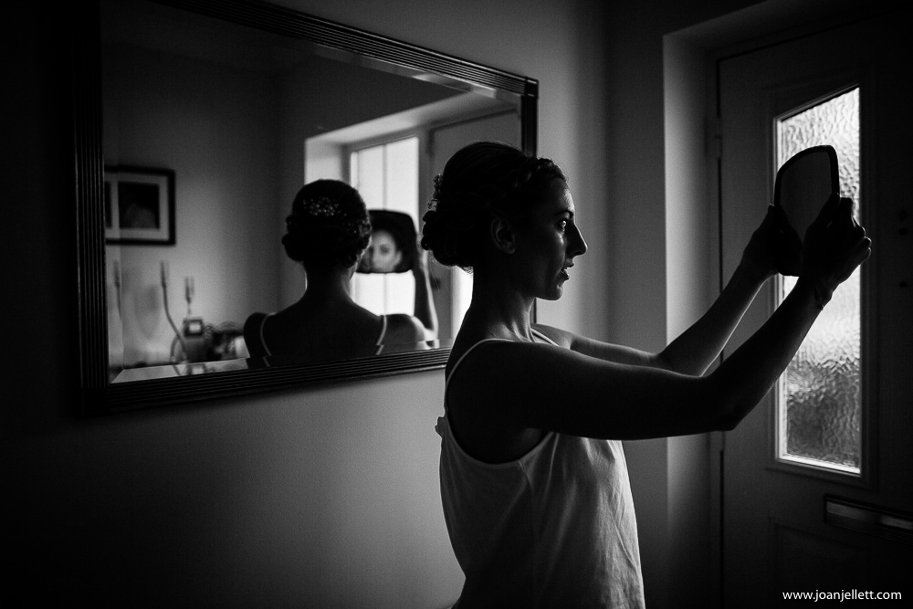 bride looking at herself in the mirror