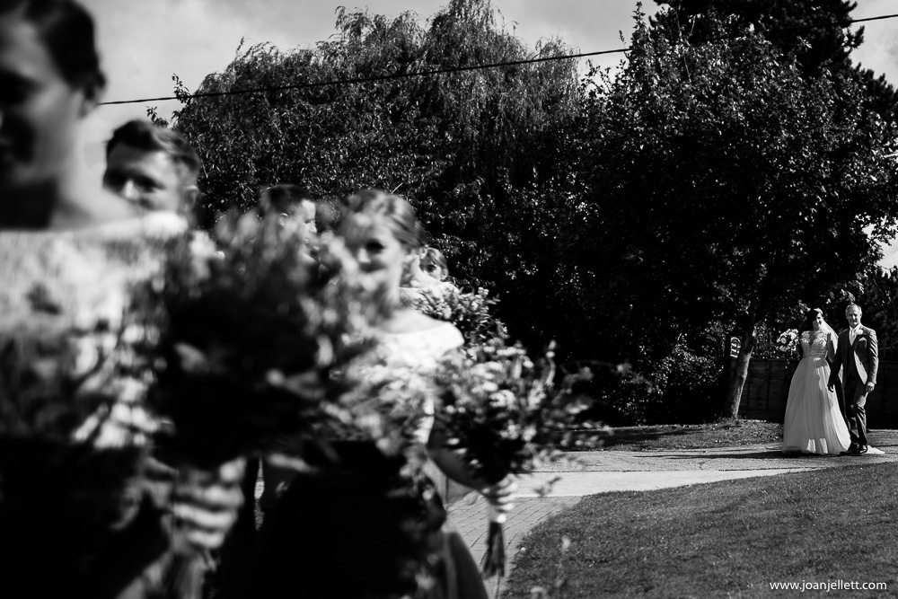 black and white shot of bride and her dad walking