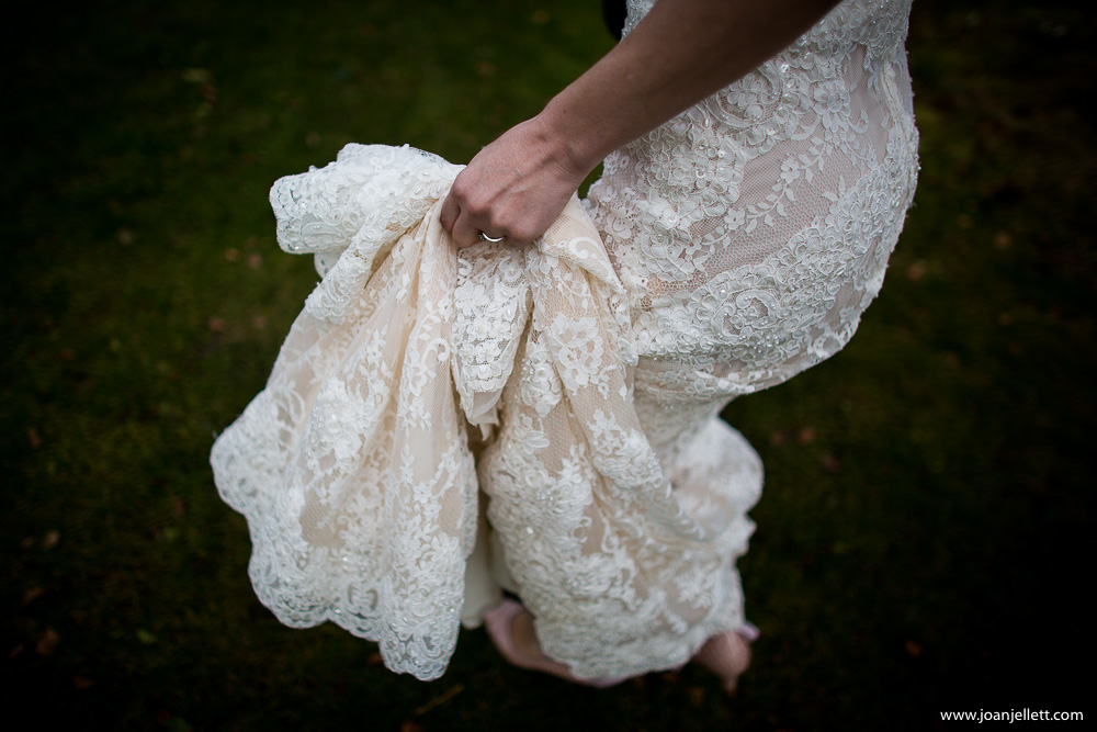 bride holding up her dress as she walks