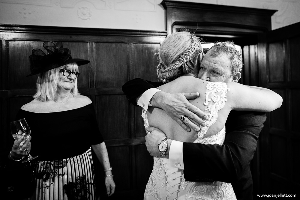 Father of the bride hugging his daughter