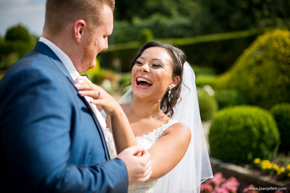 bride laughing with her groom outside