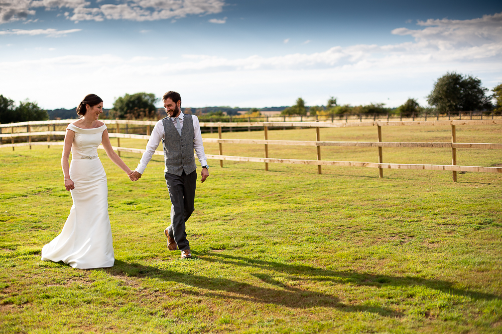 bride and groom walking hand in hand Coltsfoot Country Retreat Wedding