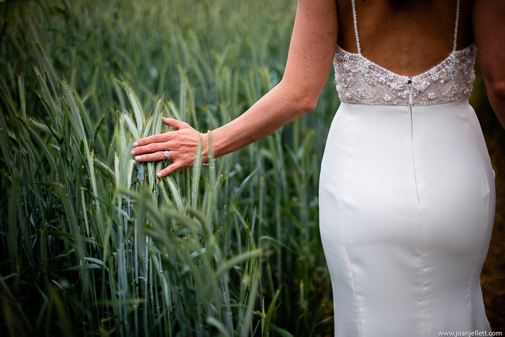 bride touching the grass with her hand softly