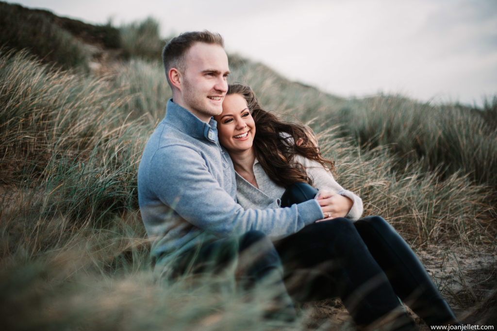 fiance smiling and looking to the distance in hengistbury head