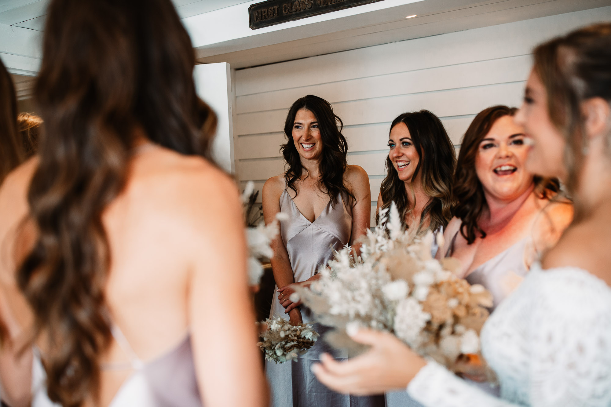 bridesmaids smiling looking at eachother