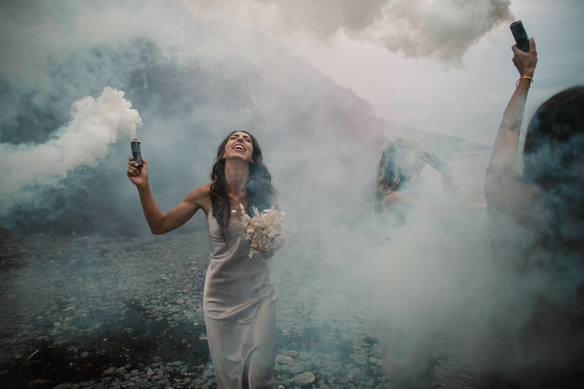 bridesmaid in the middle of the smoke laughing looking up
