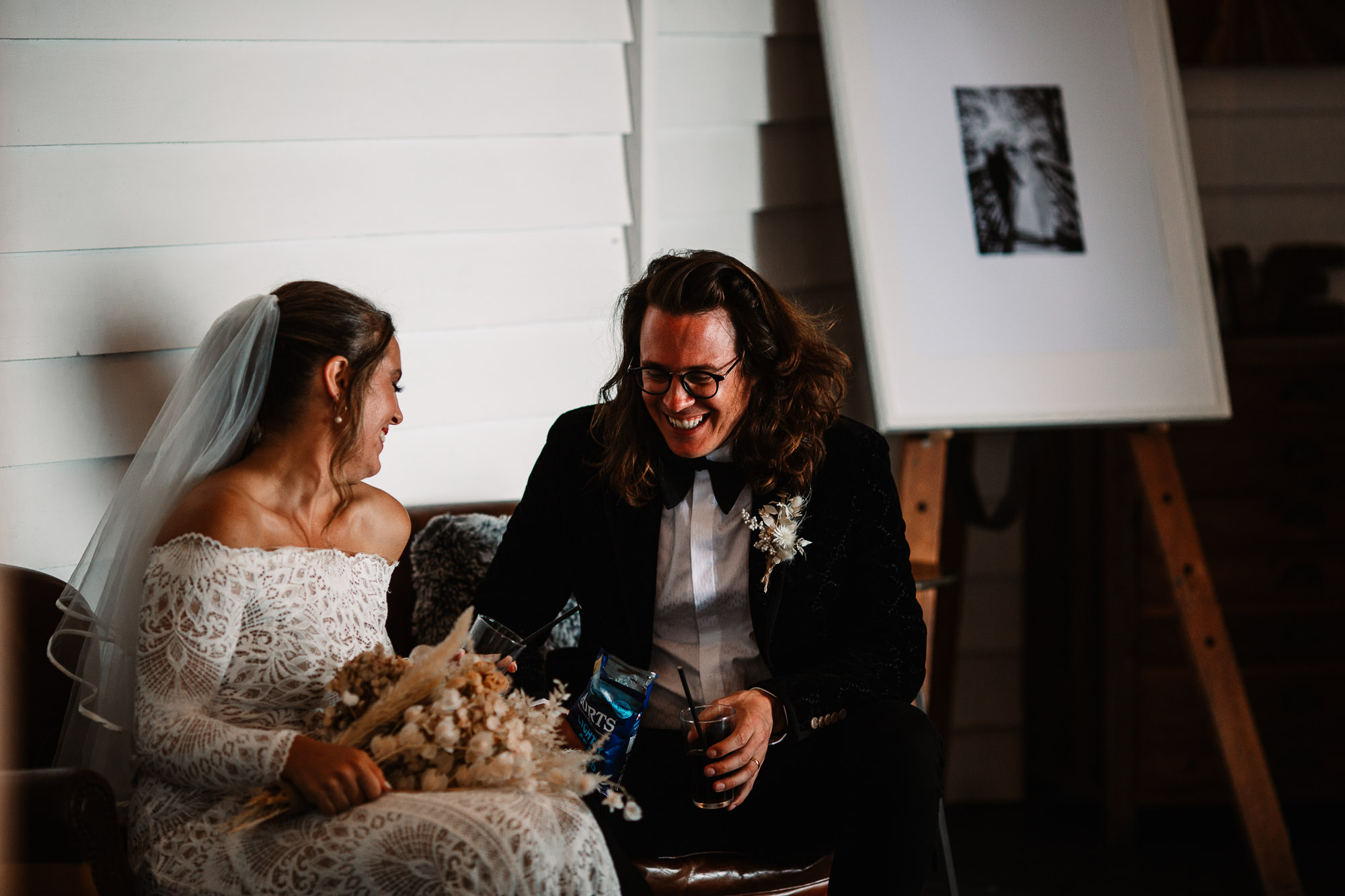 Groom and bride laughing before being announces for dinner