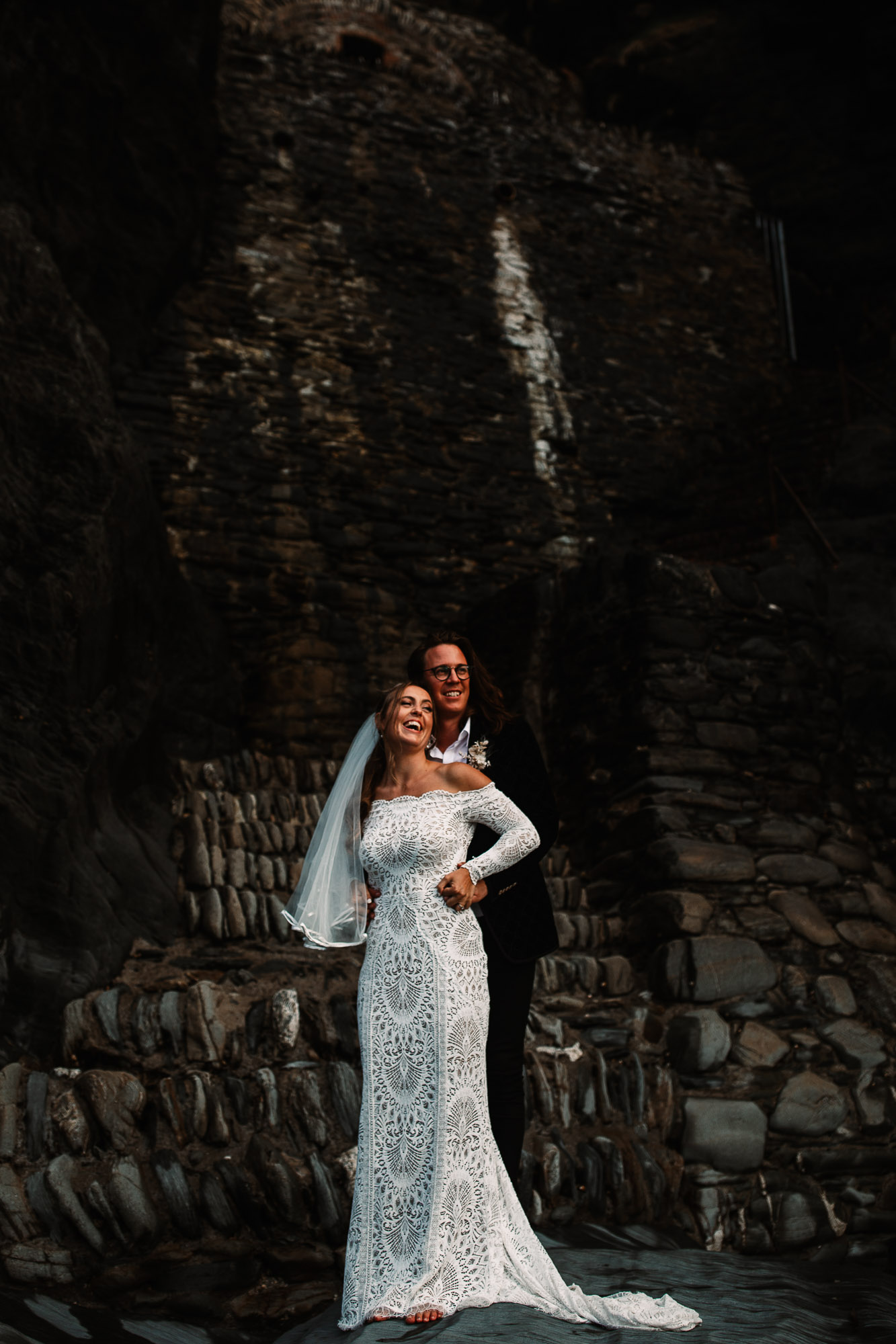 bride and groom hugging at tunnels beaches golden hour