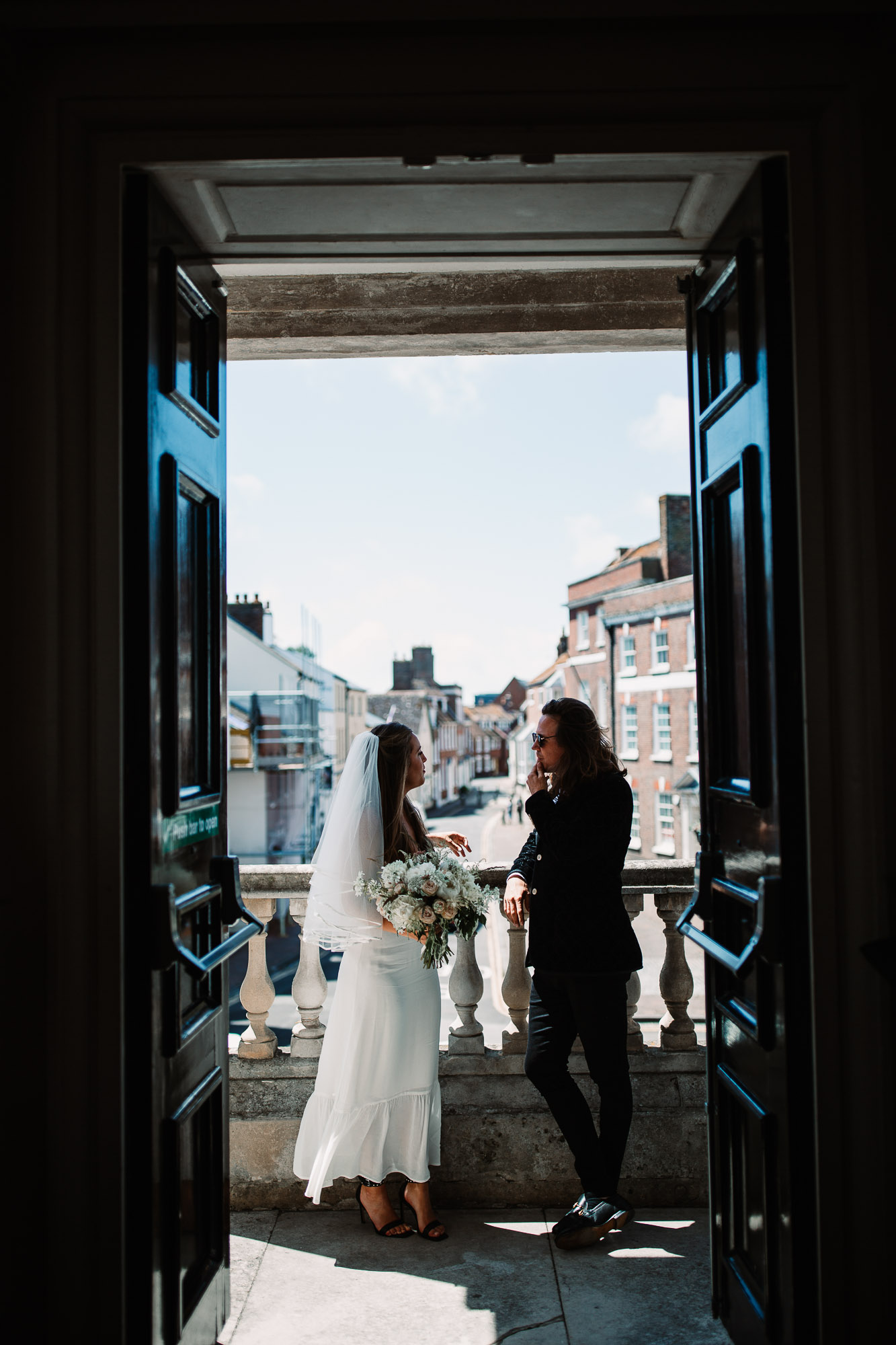bride and groom at the balcony in poole registry office