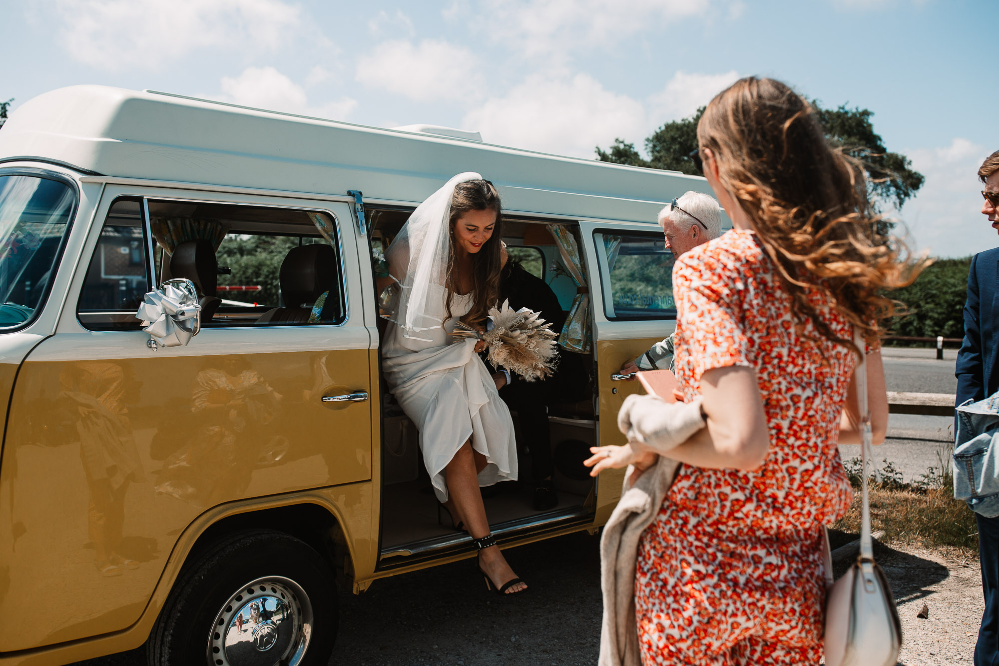bride coming out of her campervan