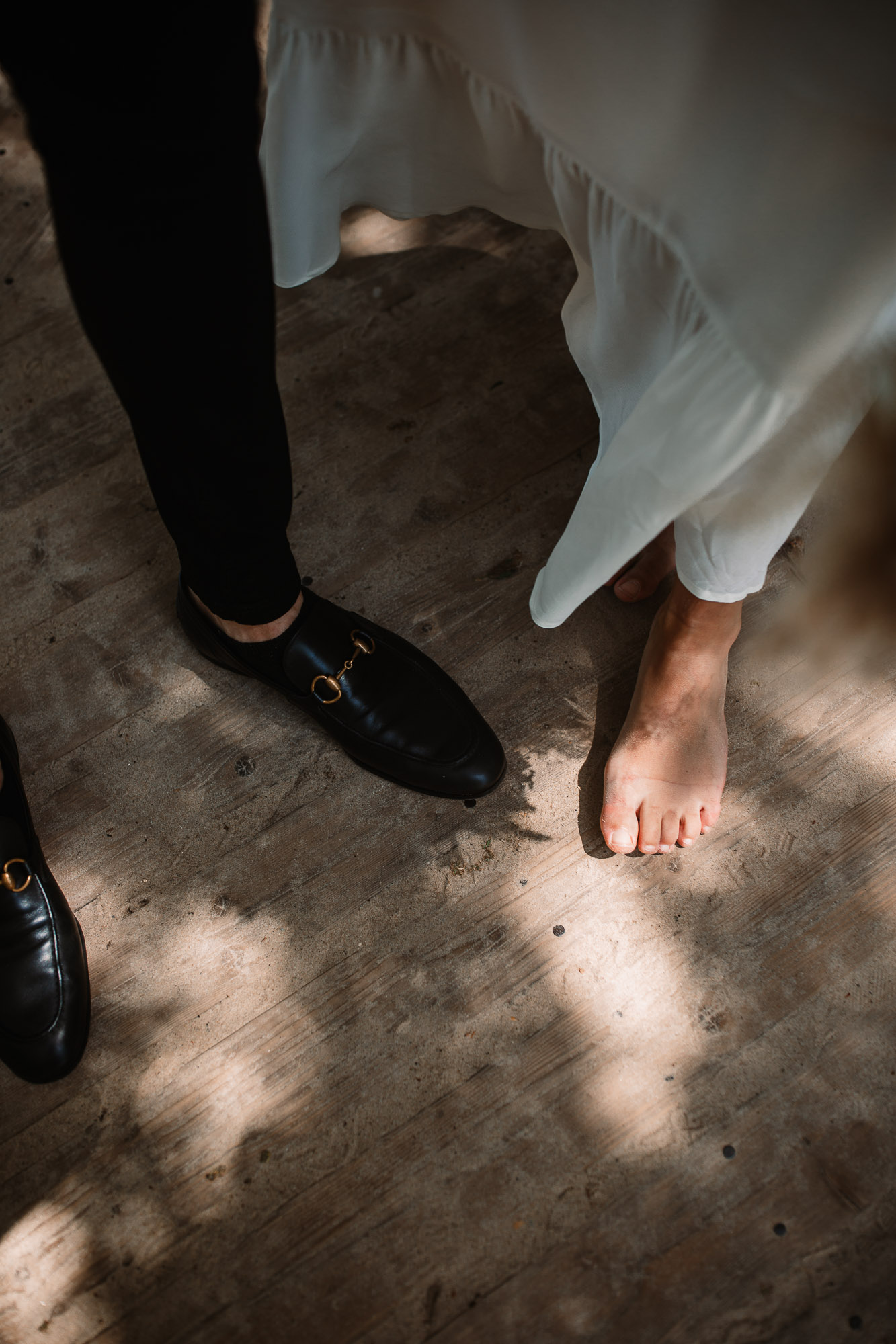 close up shots of bride and groom's bare feet on the beach