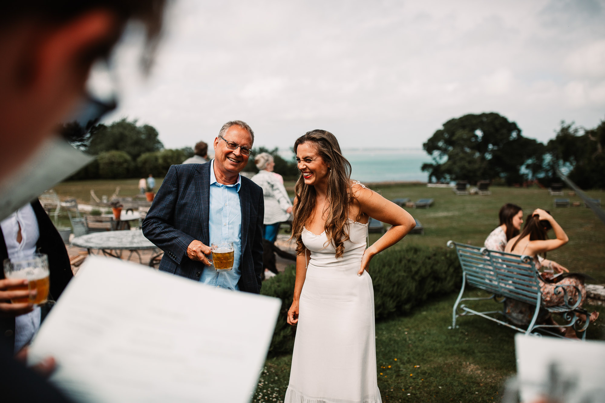 bride and father in law exchanging a joke and laughing in studland