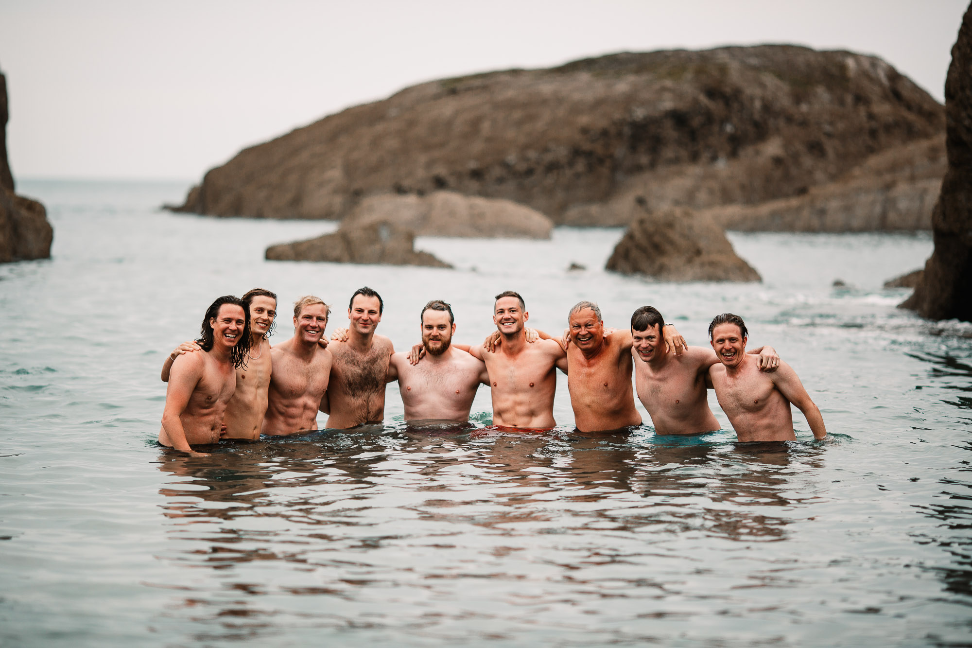 groom and his friends in the water swimming