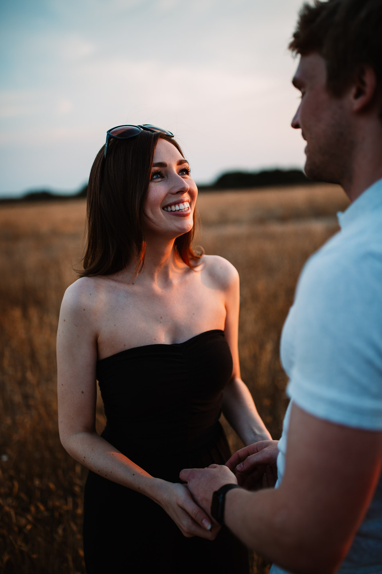 Man laughing looking at woman with hands on hips