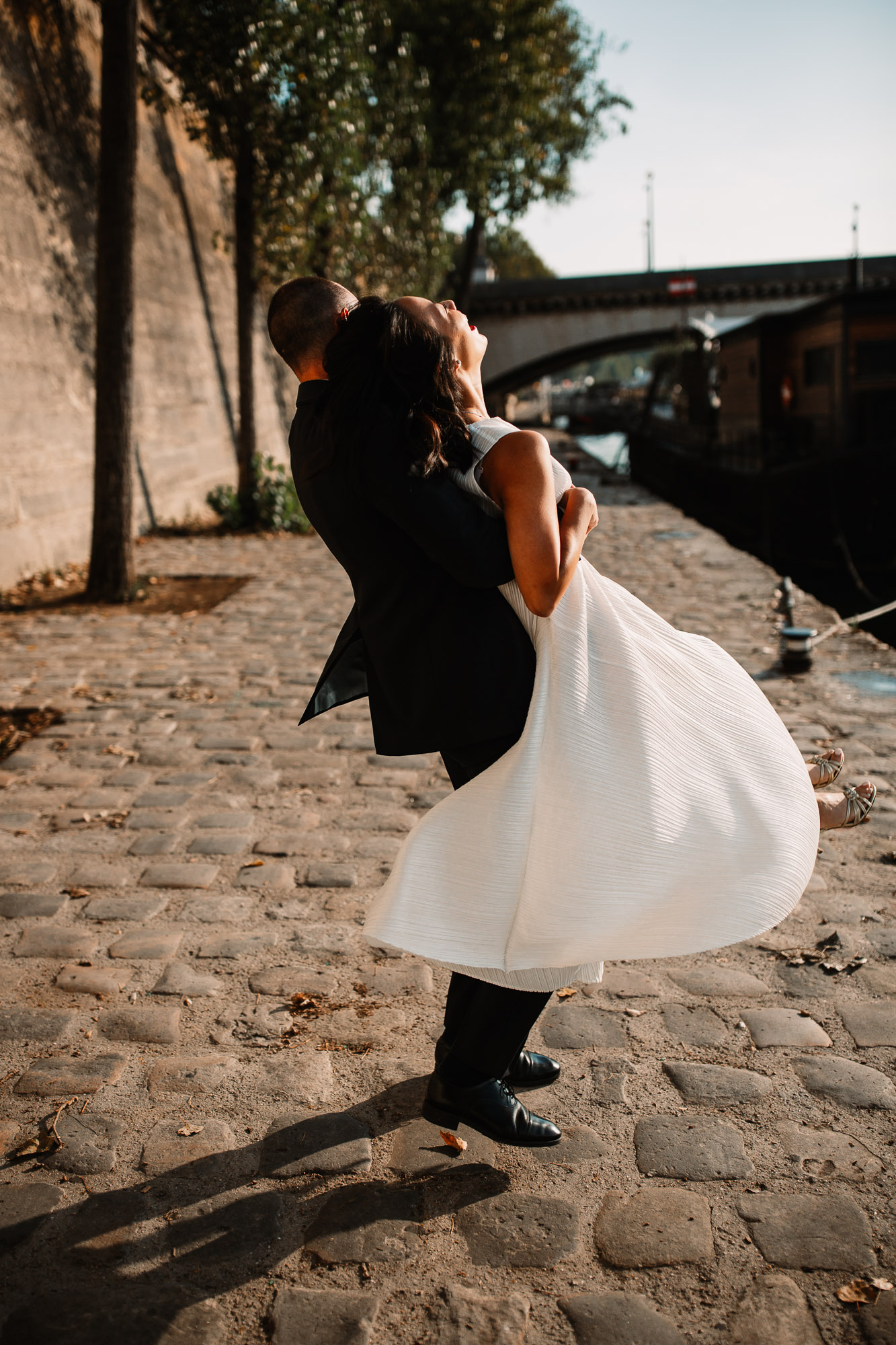 bride in her grooms arms being spinned into the air in paris