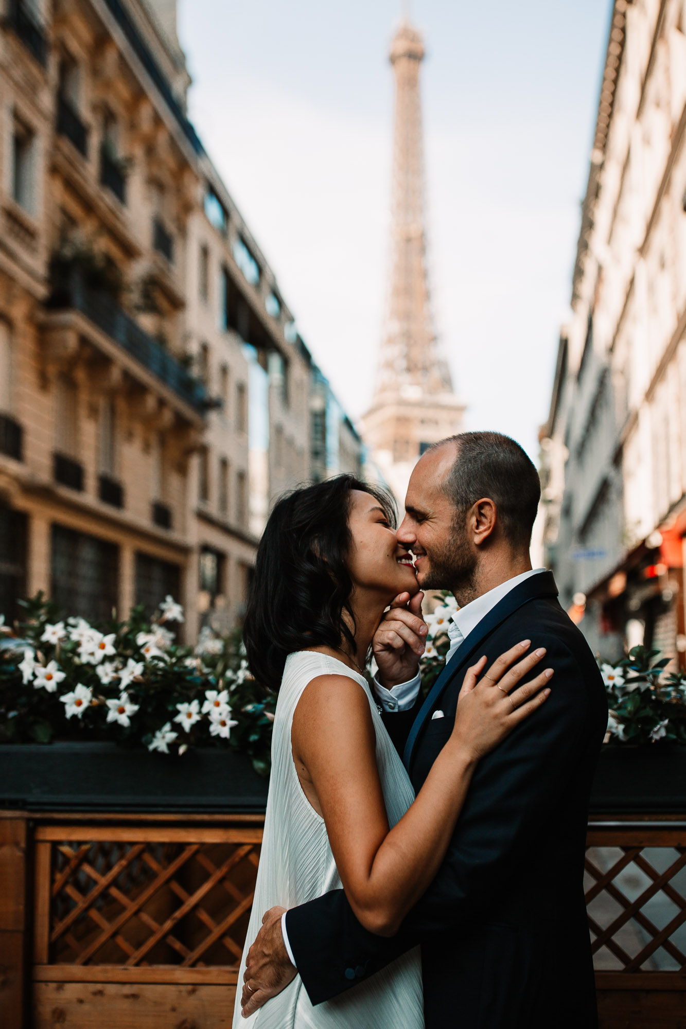 bride and groom kissing in front of the Eiffel tower