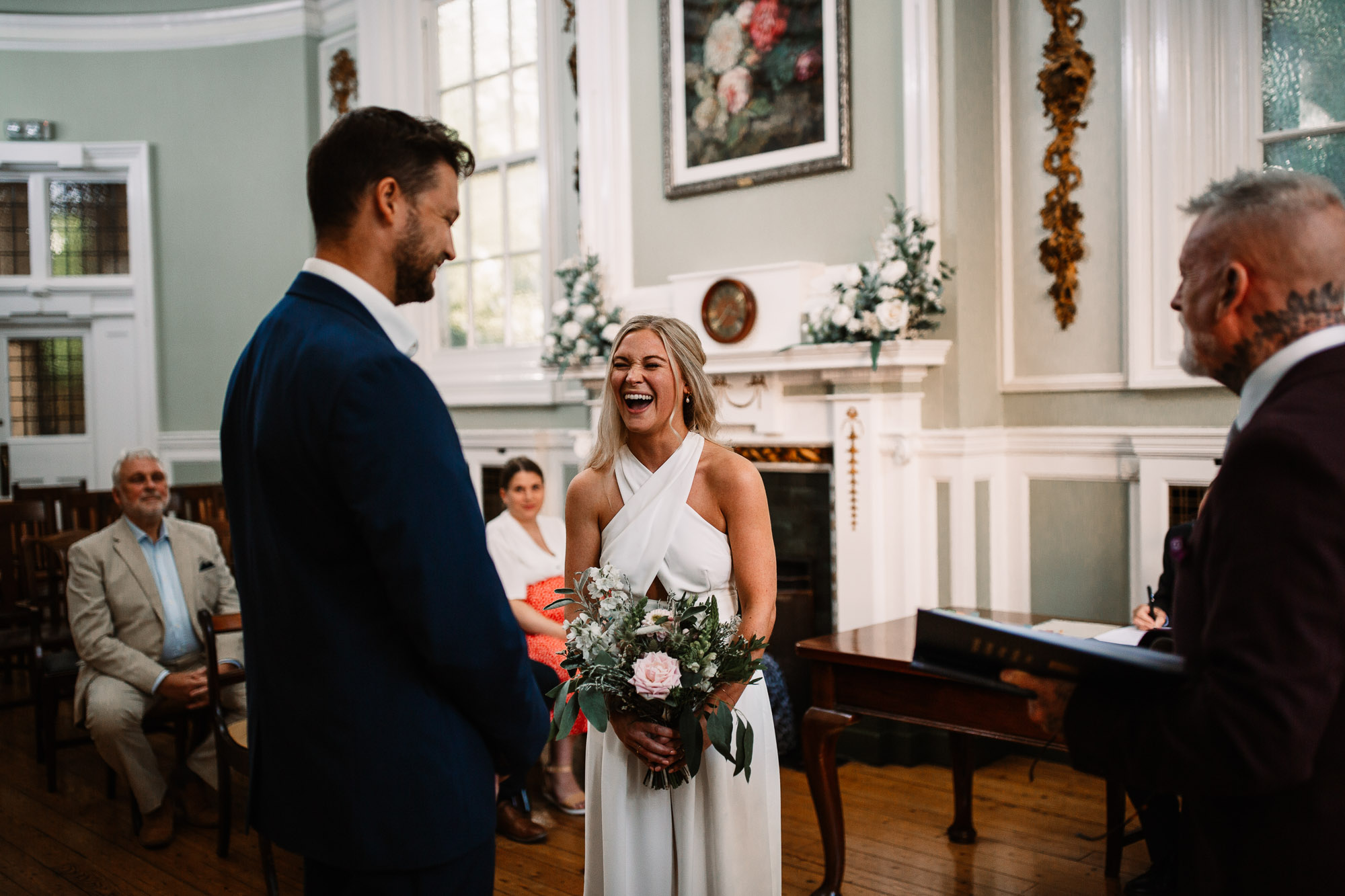 bride laughing at loud at the altar with the groom in bournemouth