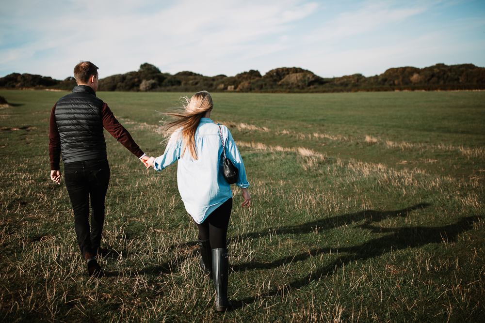 back shots of newly engaged couple in old harry rocks