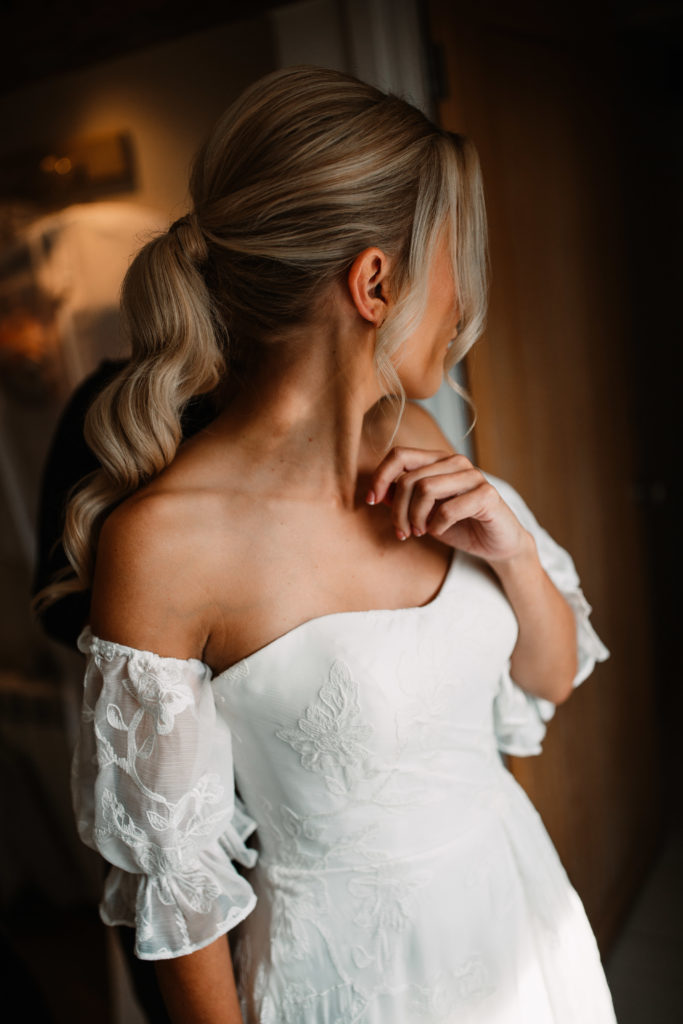 bride profile shot with her hair in a ponytail