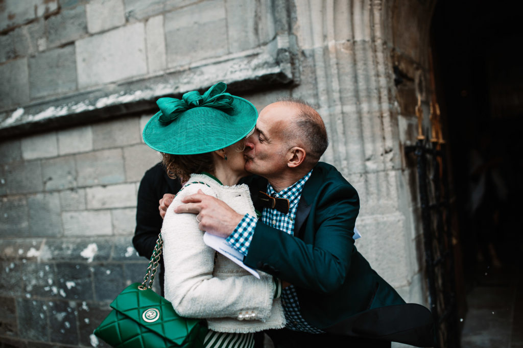 guests kissing outside the church