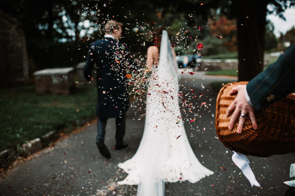 Confetti shot of a basket being thrown at the bride and groom