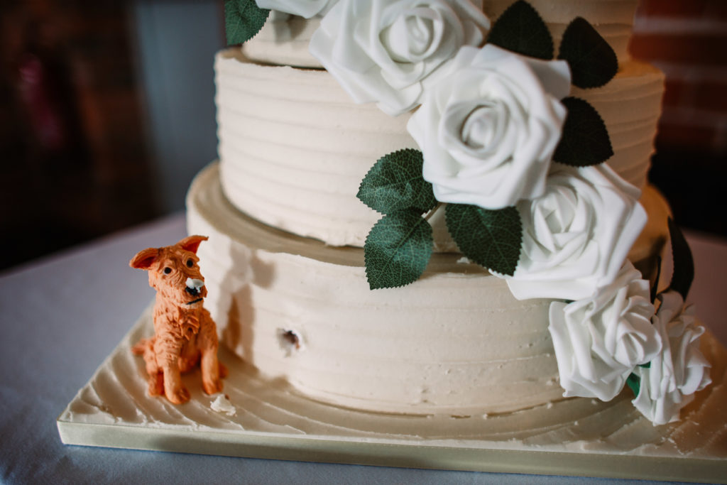 detail shot of the cake being eaten by a little fake dog