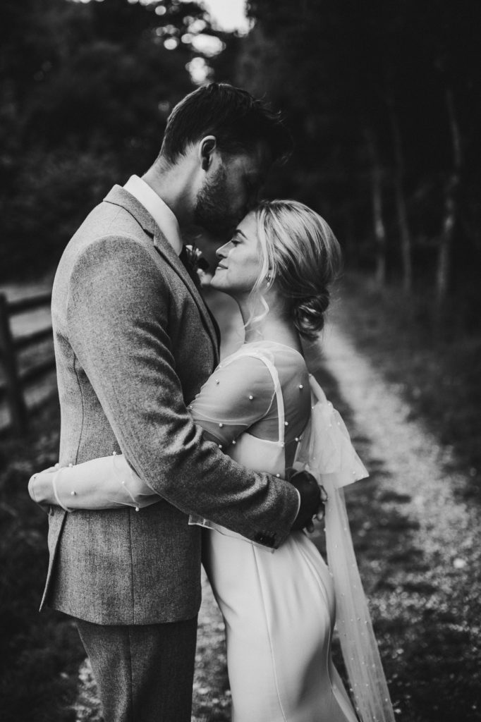 black and white shot of couple kissing