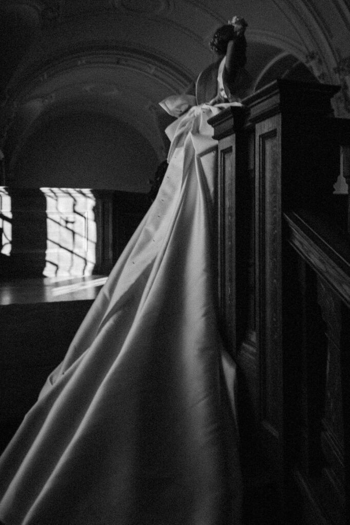 black and white shot of bride walking up the stairs to get changed