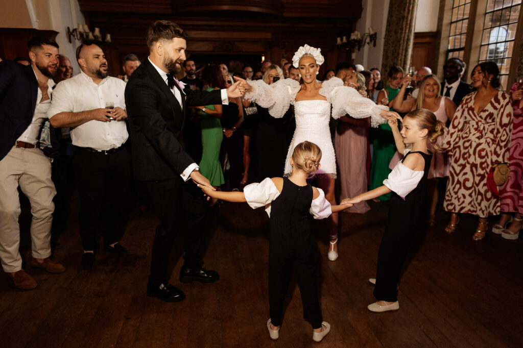 family of bride dancing holding hands on the dancefloor