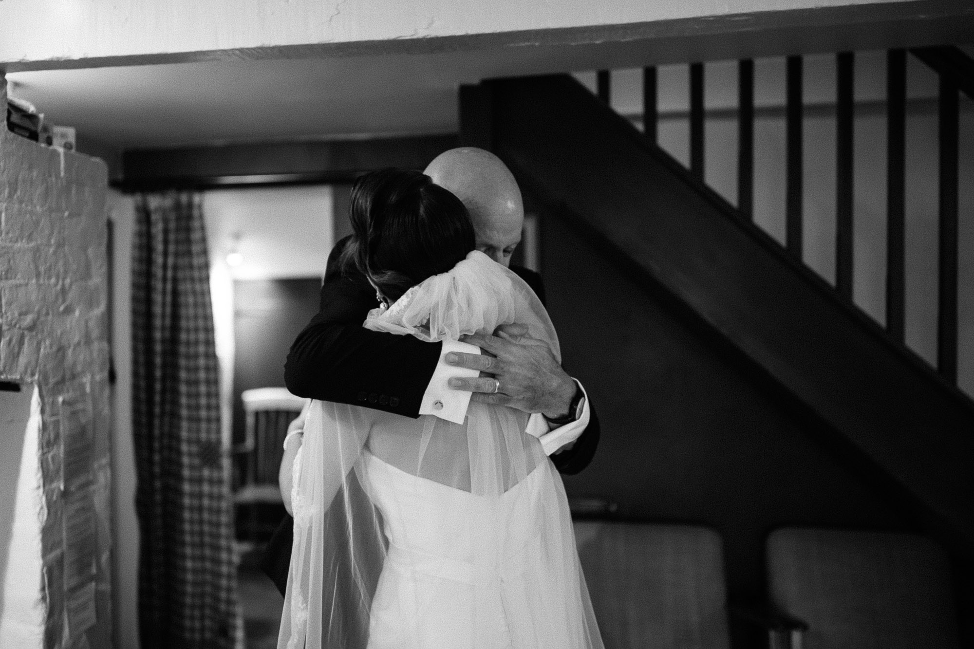 black and white shot of bride hugging her father