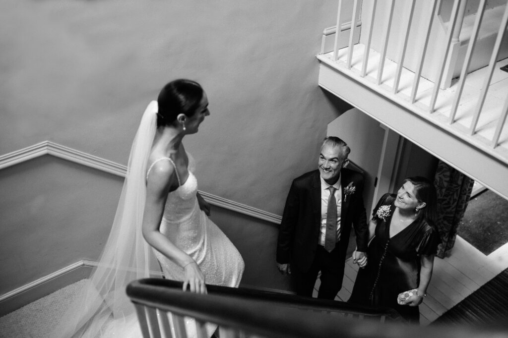 bride walking down the stairs in black and white