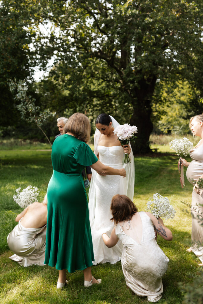 bride being adjusted by her girls before seeing her groom for the first time